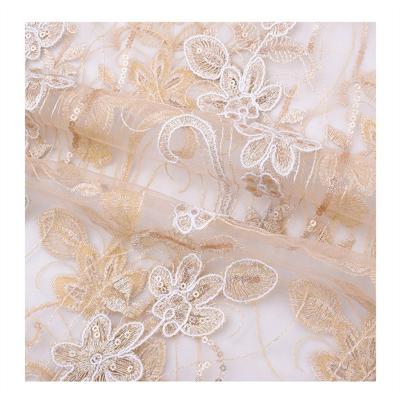 China Customized 100% bridal water soluble polyester sequin lace fabric beautiful flower design champagne color tablecloth for sale