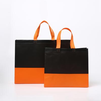 China Customized luxury shopping bags with logos orange nonwoven shopping bag Te koop