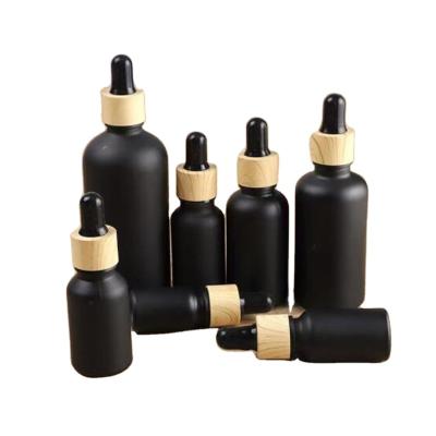 China Free Sample Cosmetic Matte Black Coating Dropper Bottle Essential Oil Glass Bottle With Gold Dropper Cap for sale