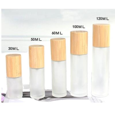 China 30ml 50ml 60ml 80ml 100ml 120ml Cosmetic Cylinder Glass Frosted Bamboo Lotion Pump Bottle for sale