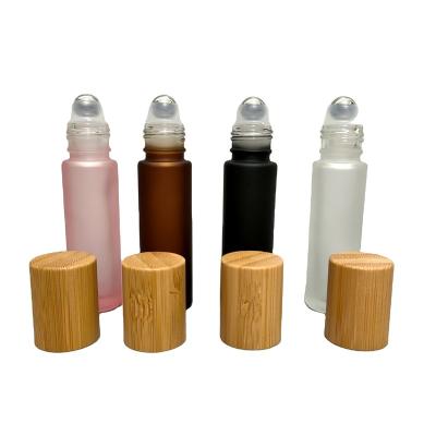 China Personal Care Empty Bamboo Lid Clear Amber Frosted Glass Roll On Bottle With Steel Roller Ball 5ml 10ml For Perfume for sale