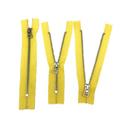 China Auto Lock Automatic Slider With Yellow Cloth Metal Zipper Garment Zipper for sale