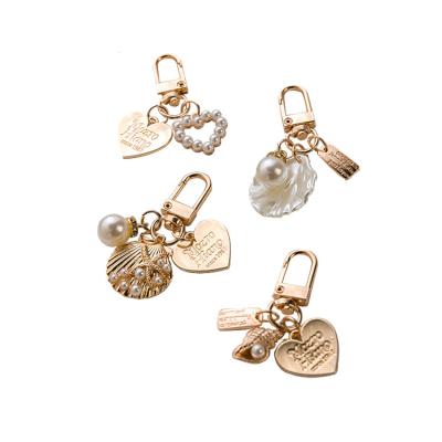 China Environmental Friendly Cute Girl Bag Accessories Charm Car Keychain Gold-color Gift for Lover Trinket Love Letter Conch Pearl Key Chain for sale