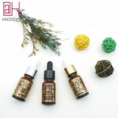 China HAODEXIN Luxury 10ml 0.34oz Dropper Bottle Stamp Gold Amber Glass Eye Dropper Hot Essential Oil Glass Bottle With Pipette Nitriles Bulb for sale