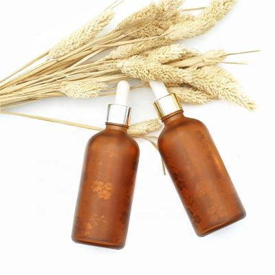 China Amber Essential Oil HAODEXIN 100ml Flower Cosmetic Bottles Matte Essential Oil Decal Pattern Amber Matte Bottles With Gold Silver Dropper for sale