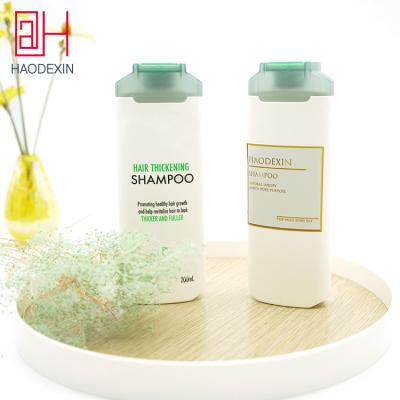 China HAODEXIN Duo Color Modern Cap Recycled HDPE Shampoo Squeeze Bottle With Flip Cap Top Conditioner Bulk Plastic ACP Bottles Manufacturer for sale