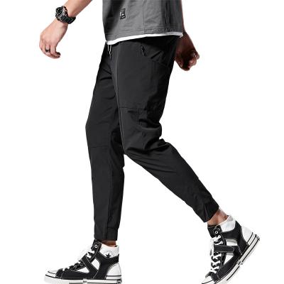 China Anti-Static Mens Big Stretch Drawstring Pants Loose Knitted Sports Trousers Casual Straight Tube Custom Logo for sale