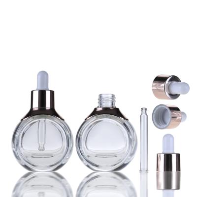 China Cosmetic Luxury Cosmetics Packaging Flat Round Essential Oil Clear Dropper Glass Perfume Bottle 30ml 50ml for sale