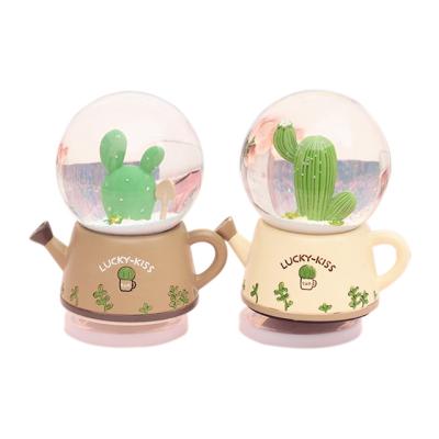 China Cool Funny Gift Tech Decoration Cactus Snowball Musical Box Glass Snowball Souvenir Music Box for sale