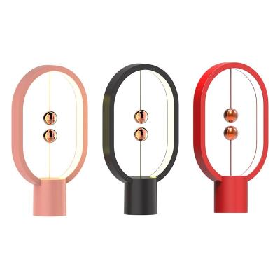 China Modern USB Powered Minimalist LED Table Lamp Magnetic Balance Ellipse Earth Switch Eye-Care Table Lamp for sale