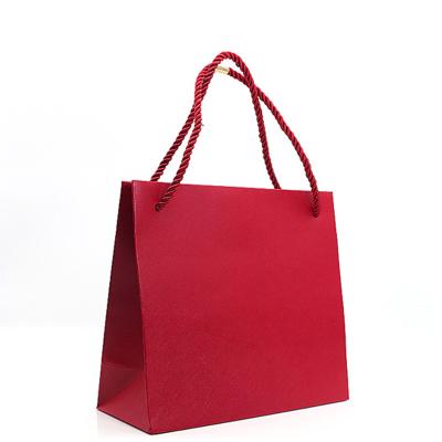 China Handmade Wholesale Luxury Blue Red Paper Bags Printed Logo Custom Packaging Paper Bag Clothing Shopping Gift Jewelry for sale