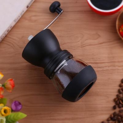 China Hotel Home Mini Black Portable Glass Jar Manual Rotary Conical Grinder Coffee Grinder for sale