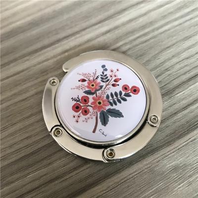 China Personalized Eco-Friendly Purse Hangs Custom Logo Folding Handbag Hanger Holder for sale