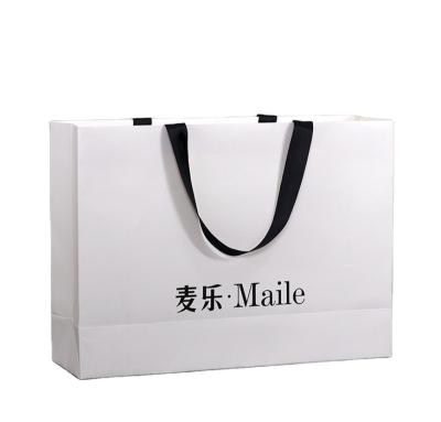 China Recyclable custom luxury clothing retail bag packing bolsas de papel pink shopping bag gift packaging paper bags with handles for clothes for sale