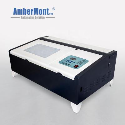 China MINI Portable Desktop Rubber/Wooden/Plastic/Glass CO2 Laser Engraving Stamp Polymer Rubber Pad Wood Pre-ink Stamp Laser Engraving Making Machine for sale