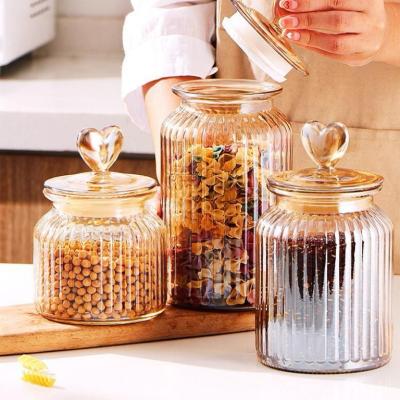 China Heart shaped lid, glass jar, sealed jar, colored storage jar, household flower tea storage, candy and snack jar for sale