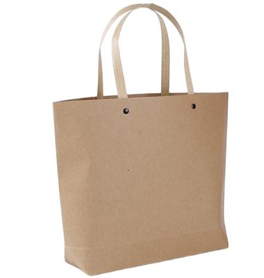 China Wholesale Custom Made Trapezoidal Handbag Recycled Materials Manufacturer Apparel Kraft Paper Bag Rivet Packing Bag Gift Wrapping Handbag for sale