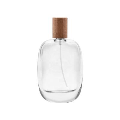 China 100ml Clear Perfume Orderly Bottle With Wooden Lid For Perfume Oil Glass Bottle for sale