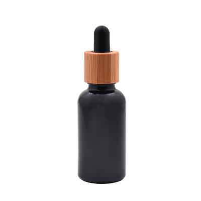 China Essential Oil Nature Black Dropper Bottle Essential Oil Glass Bottle with Bamboo Cap in 5ml to 100ml for sale