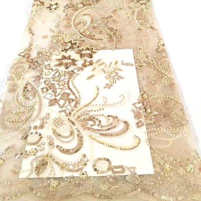 China New large 3d flower heavy Nigerian bridal luxury high quality French breathable Champagne beaded sequin embroidery lace fabric for dress for sale