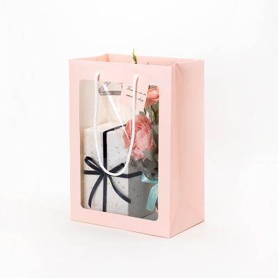 China Recyclable Gift Bags With Windows Doll Jewelry Paper Gift Bags With Flower Handles Wedding Food Gift Waterproof Packaging Bag Custom Logo for sale