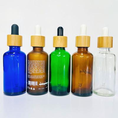 China Personal Care Screen Printing Amber Glass Frosted Essential Oil Glass Bottles With Bamboo Dropper And Bamboo Bottle Pump for sale