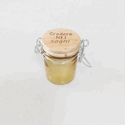 China Mini 50ml Viable Amber Color Glass Jar With Wooden Lid Printing Logo Glass Storage Jar With Swing Top for sale