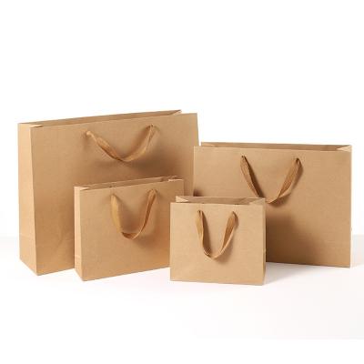 China Custom high quality eco-friendly kraft paper bag printed logo luxury white handle gift shopping bag with silk ribbon band for sale