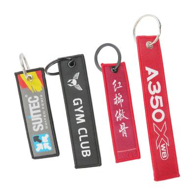 China Polyester Size Quality Design Privated Custom Woven Keychains Backing Embroidered Key Indicators Cloth Wholesale Keyring for sale