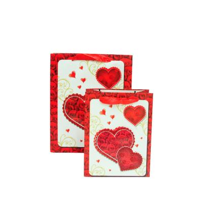 China Recyclable Glitter Pink Print Decorated In Red Heart Shapes Luxury Paper Bag Bag For A Gift Box Ribbon Wedding Paper Bag for sale