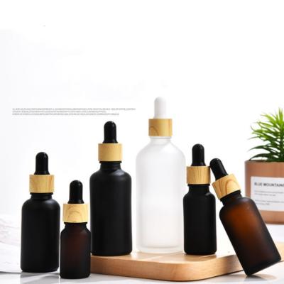 China 1oz 30ml 50ml Black Essential Oil Serum Bottles Glass Cosmetic Luxury Dropper Bottles for sale