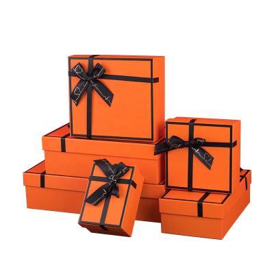 China Recyclable Lid And Base Box Orange Bows Large Small Paper Gift Packaging Boxes With Ribbon Custom Logo for sale