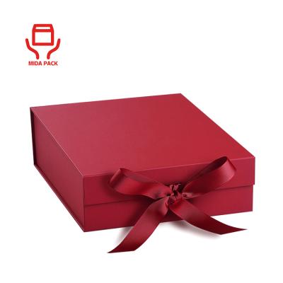 China Recycled Packaging Materials Luxury Custom Magnetic Flap Lid Cardboard Foldable Paper Wrapped Gift Box With Ribbon For Clothing Cosmetic Skin Care for sale