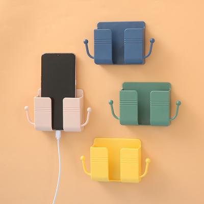 China Viable Wall Mount Accessories Adhesive Mobile Phone Cell Phone Wall Charger Holder and Universal Remote Control Holder Storage Box for sale