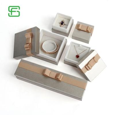 China Mini Travel Custom Paper Jewelry Cardboard Elegant Gift Ribbon Fashion Jewelry Packaging Boxes for sale