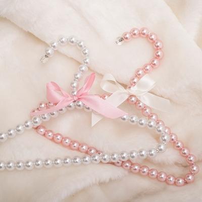 China Eco-friendly Creative Cute Design Clothing Store Princess Dress Plastic Pearl Hanger for sale