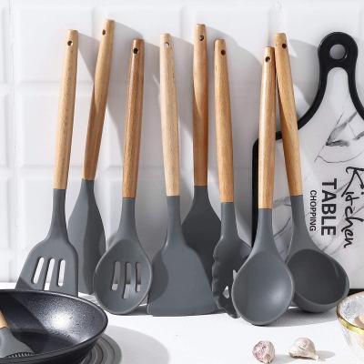 China Sustainable Non-Stick Food Grade Cookware 12Pcs Kitchen Tool Kit Silicone Cookware Set With Wooden Handles for sale