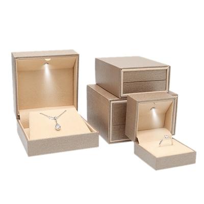 China Modern Customized Ring Gift Box Packaging Small LOGO Light LED Slide Jewelry Boxes OEM Luxury Jewelry Store Custom Made Jewelry Boxes for sale