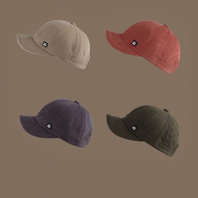 China COMMON XQL New short brim peaked baseball retro niche short brim baseball caps spring and autumn hat men and women trendy custom made for sale