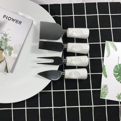 China Sustainable Wholesale Western Dinnerware Four-piece Stainless Steel Porcelain Handle Butter Cheese Knife Fork Set for sale