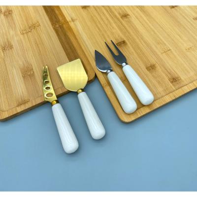 China Sustainable 5 Pcs Custom Brand Hard Polish Wholesale Kitchen Cheese Knife Set With Black Gift Box for sale