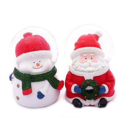 China 2021 Resin Santa Claus Crystal Ball Christmas Gift Resin Opens Gifts Snow Globe for sale