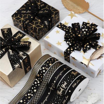 China Recyled customized logo brand black satin ribbon, 1 inch 25mm printed matte gold foil satin ribbon for gift wrapping for sale