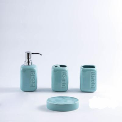 China Sustainable Wholesale Household Ceramic Accessory Simple Design Four Piece Bathroom Set With Relief Logo for sale