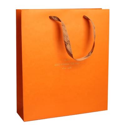 China Recycled Materials Customized Luxury Orange Gold Foil Cosmetic Gift Paper Bag Packaging for sale