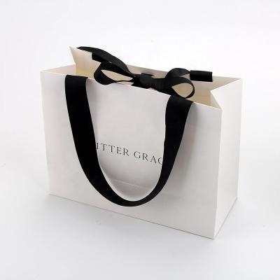 China Recyclable Printing Foldable White Kraft Paper Carrier Bag With Logo Manufacturer for sale