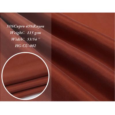 China Anti viscous twill fabric 115gsm 120D pill light silky soft cupro woven fabric Cupro fabric for dress for sale