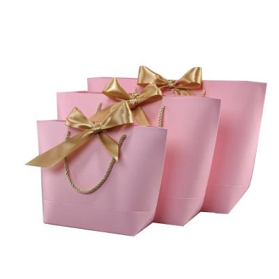 China Recyclable Fashion Custom Printing Clothes Dress Gift Bags Pink Cardboard Paper Tote Bag With Ribbon for sale