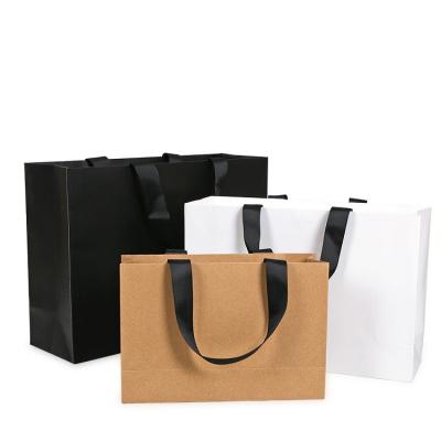 China Large Disposable High Quality Kraft Paper Shopping Clothes Shoes Paper Bag With Flat Handle for sale