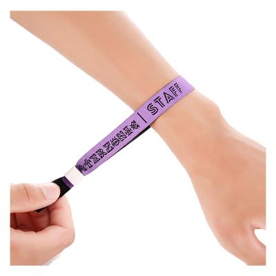 China Personalized waterproof/waterproof fabric wristband adjustable plastic tube woven fabric sliding wristband for sale